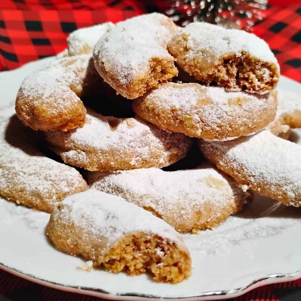 photo shows a pile of vanilla crescent cookies on a plate.