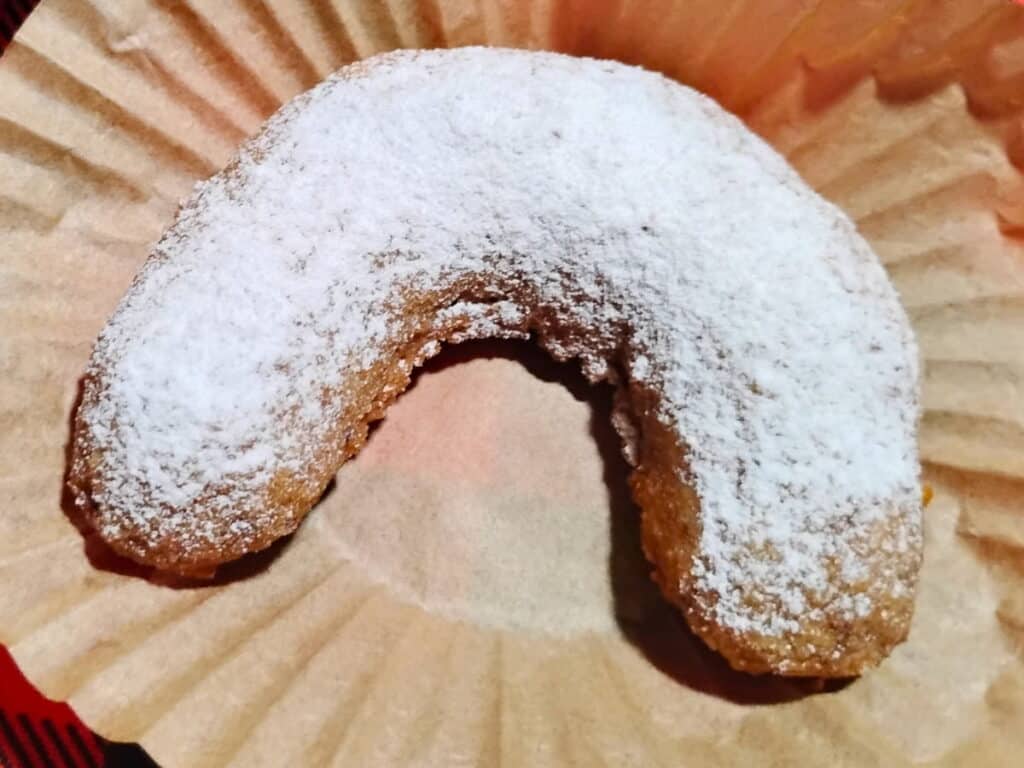 a vanillekipferl on a small piece of parchment.