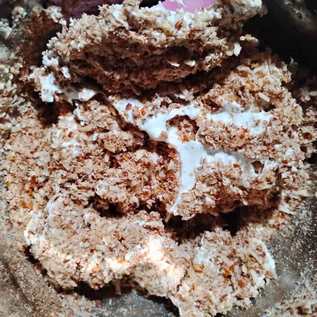 mixing of the almond meringue batter inside a bowl.