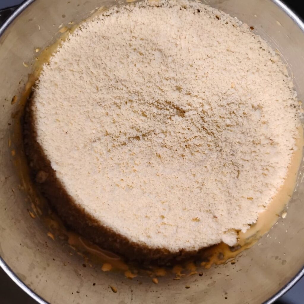 almond flour is getting added to creamed egg yolk and sugar 