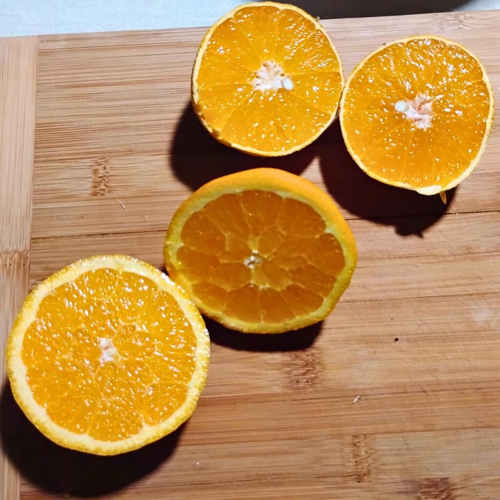 orange halves on a cutting board.