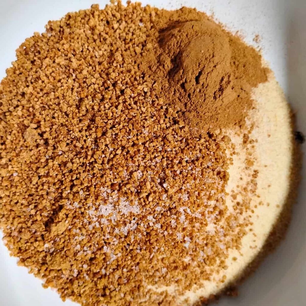 flour, panela sugar, salt, and cinnamon in a bowl before mixing.