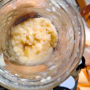 a jar with a small amount of fermented preserved lemon paste in it.
