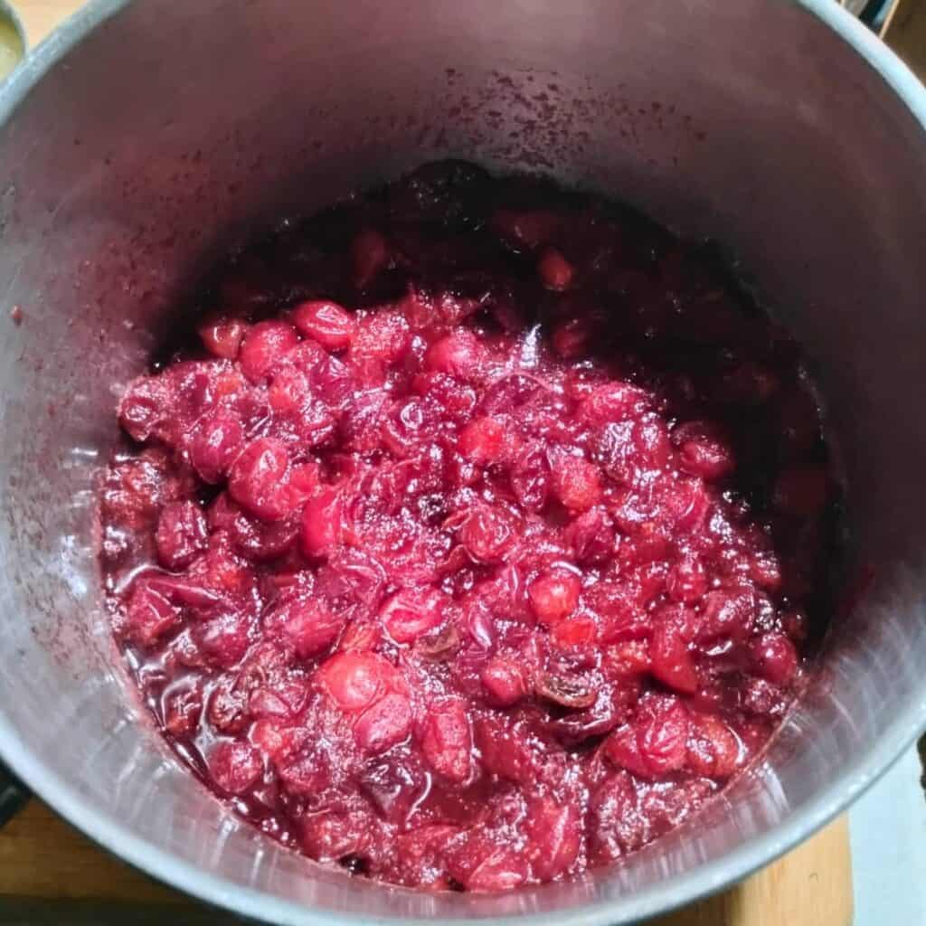 cranberry sauce cooking in a pot.