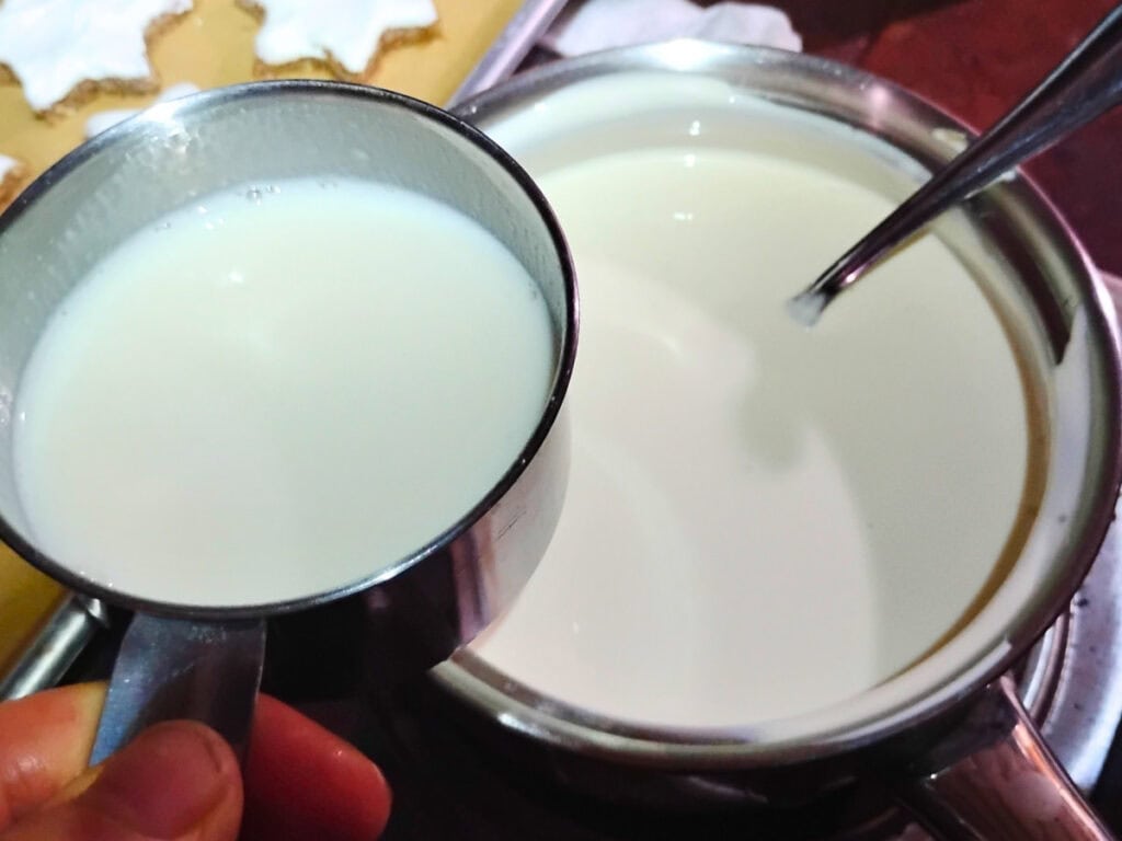 Whey is getting added to the pot of cream and half and lhalf.
