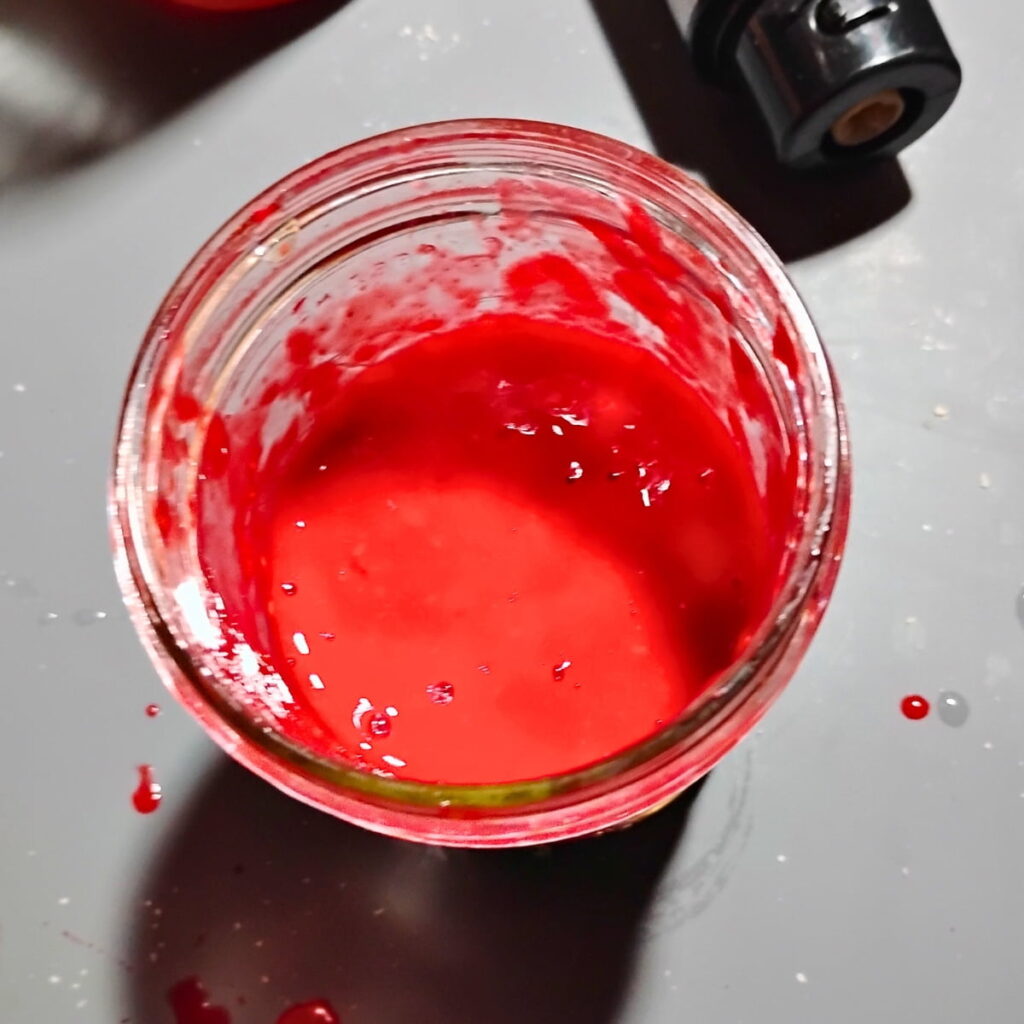 Blended raspberries in a mason jar
