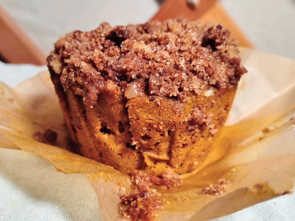 closeup photo of a muffin inside an opened up liner.