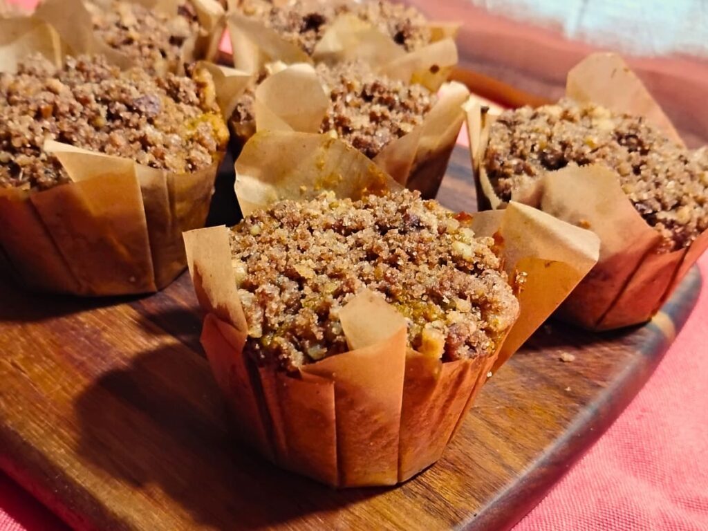 photo showing a few muffins in homemade liners on a cutting board.