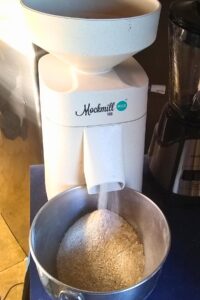 photo of a grain mill grinding kamut flour.