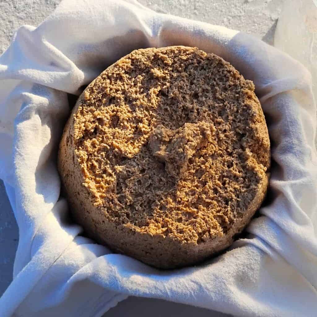 bread dough that was dumped into a cloth lined bowl. 