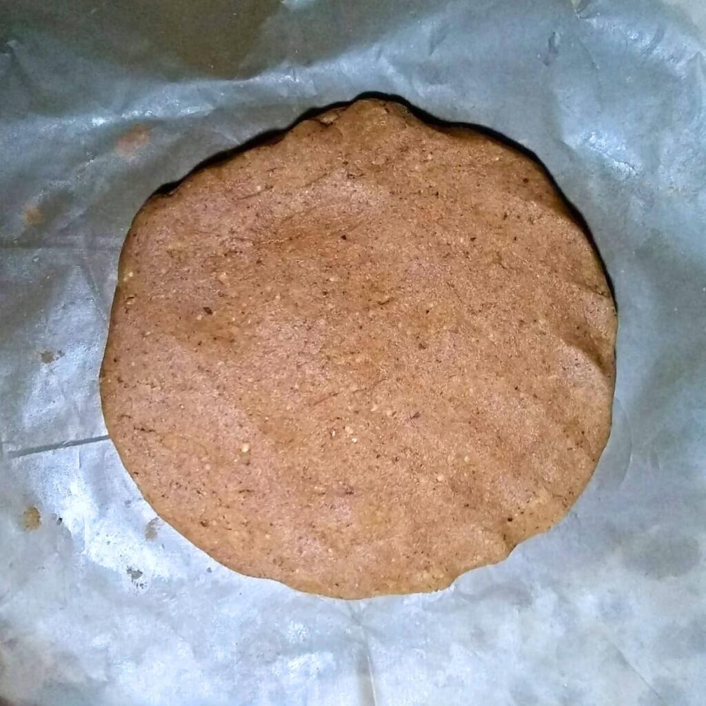 dough is pressed into a disk on parchment for chilling.