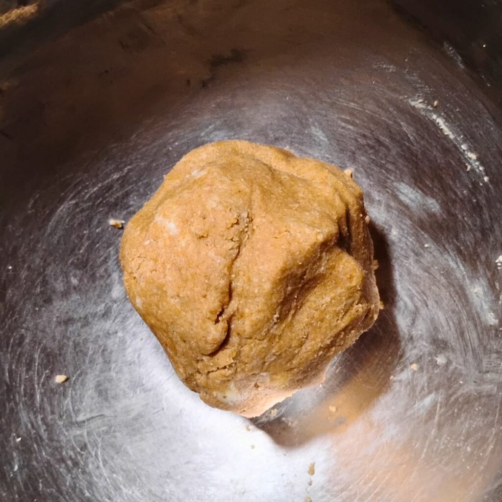 a finished dough, shaped into a ball inside a bowl