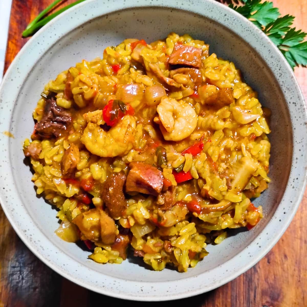 a bowl filled with shrimp and ham jambalaya