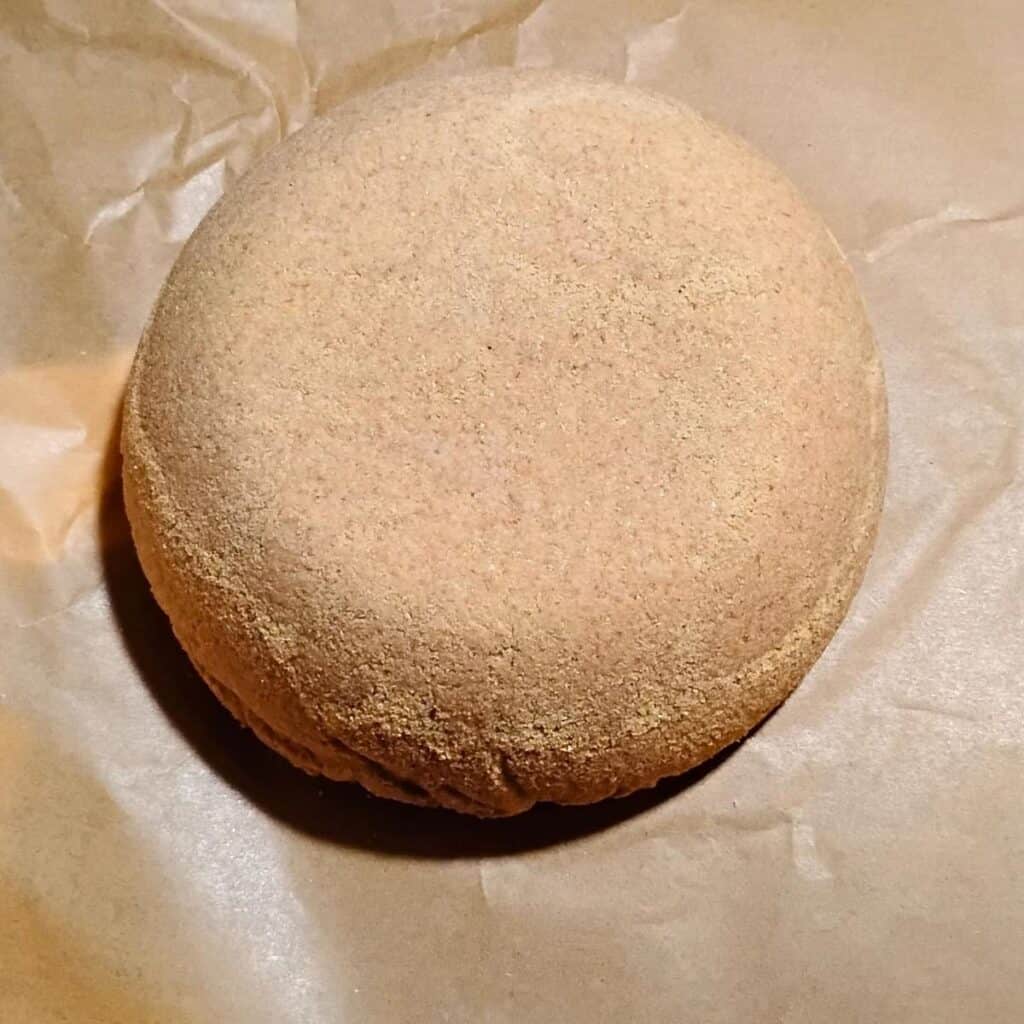 a parchment with a bread loaf dough on it 