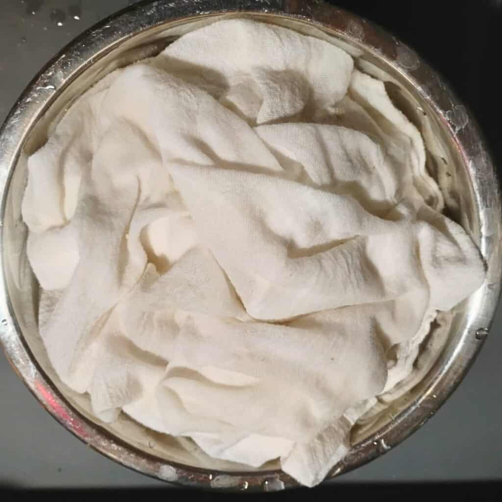 a bowl with a wet cloth in it.