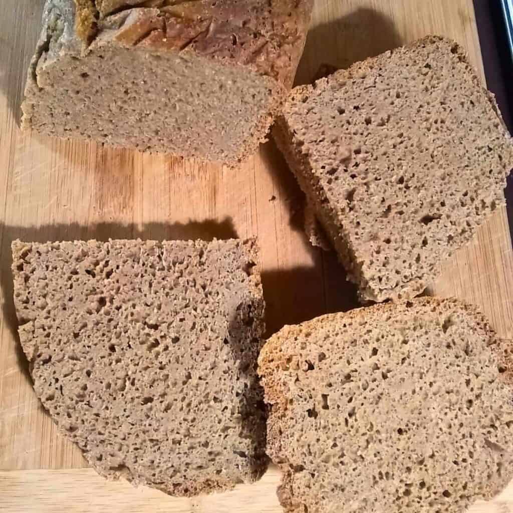 photo of sourdough rye bread sliced up on a cutting board. 