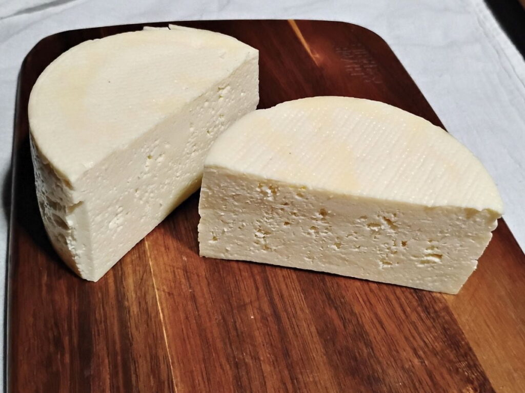 a month old cheese that has been ripening in the refrigerator and is getting wrapped for long term aging.