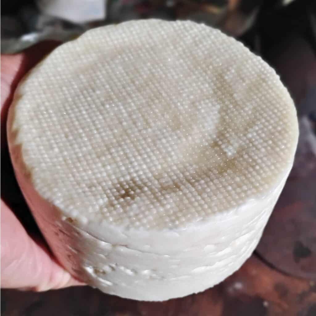 a cheese that's done draining and is ready to go into the saturated salt brine.