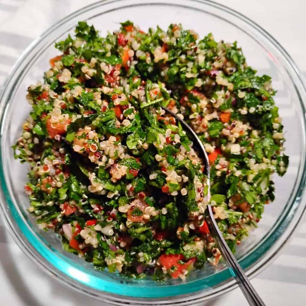 a bowl full of fresh quinoa tabouli salad.