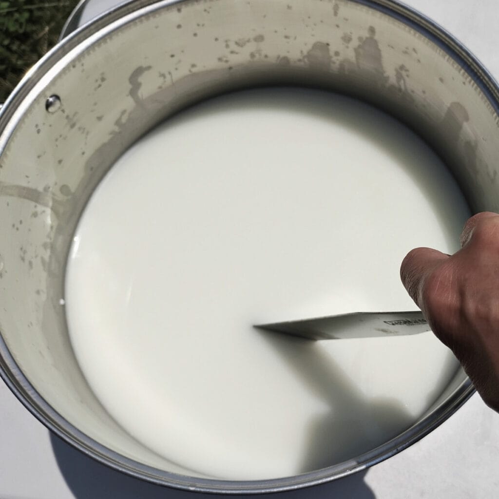 cutting the curd in a pot.