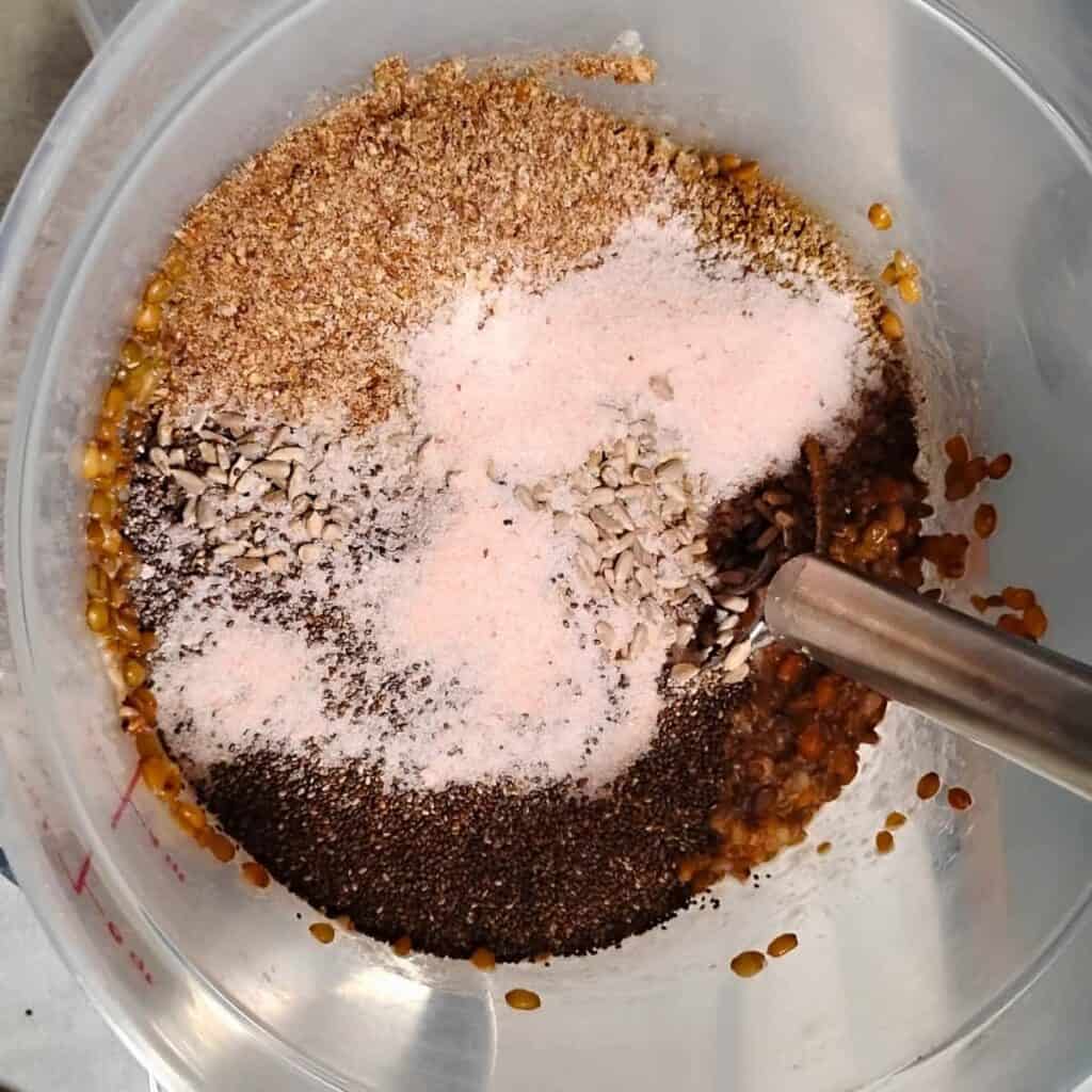 photo of ingredients in a plastic bucket with a danish dough whisk, ready for mixing.