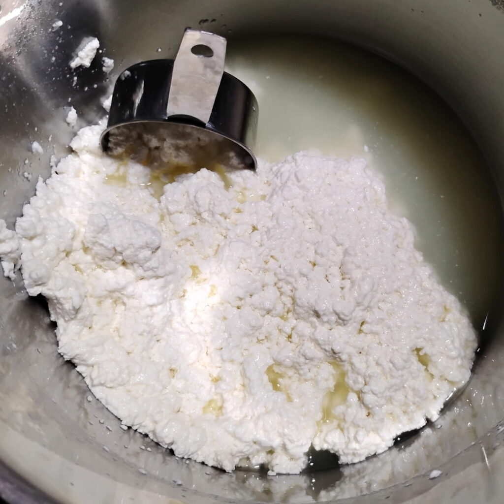 cheese curds are matting on the bottom of a pot