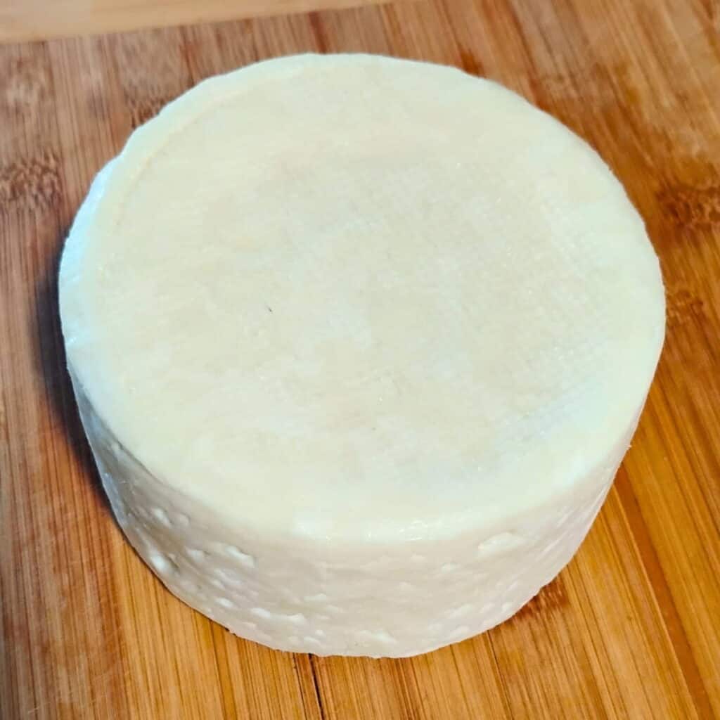 a finished bel pases cheese, ready for wrapping and long-term aging.
