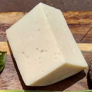 Bel Paese Cheese wedge on a cutting board
